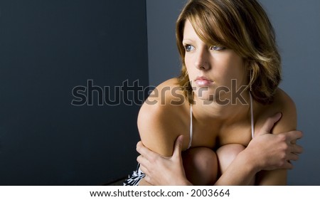 teen girl hugging her knees