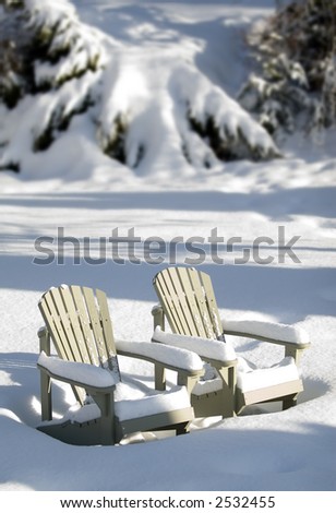 lounge chairs covered in snow