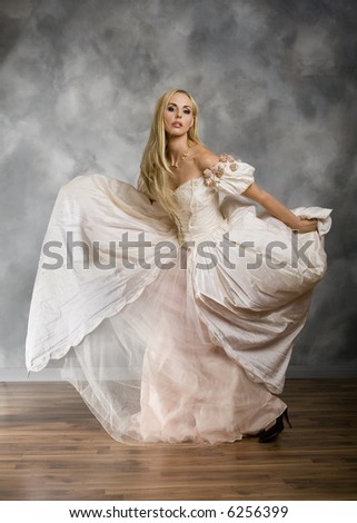 Full length view of blonde woman modeling vintage dress