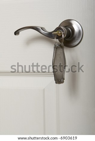 close-up view of door handle with key in lock.