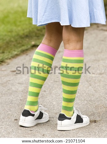 Waist-down view of a girl\'s legs dressed in a quirky style.