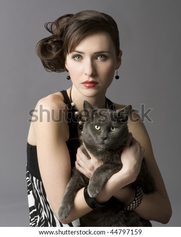 http://image.shutterstock.com/display_pic_with_logo/73989/73989,1263869383,1/stock-photo-studio-photo-of-elegant-young-woman-holding-gray-cat-44797159.jpg
