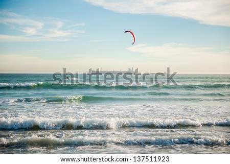 man surfing in atlantic ocean on water kite during sundown in cape town