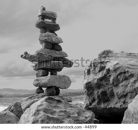 Photo of inuksuk a sculpture formed out of rock used as a marker of territory or communication. Native Art