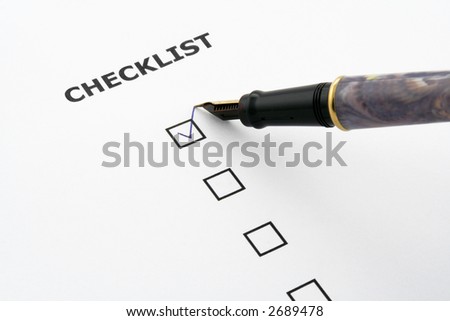 checklist with a ticked box and a pen