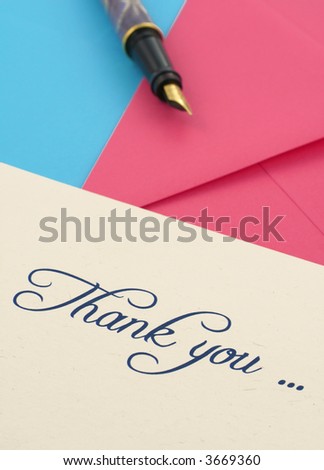 thank you note with two envelopes and a pen