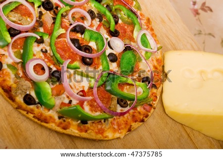 Pizza with pepperoni, green peppers, onions and olives