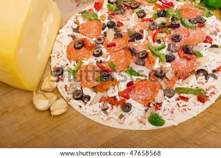 Pizza with pepperoni, green peppers, onions and olives