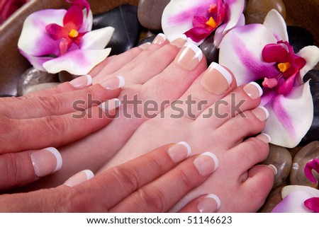 Manicured hands and pedicured feet of a woman