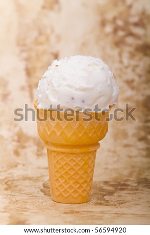 Scoop of vanilla ice cream in ice cream cone