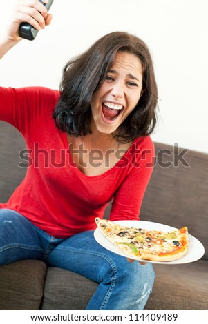 Beautiful young woman exciting in front of television