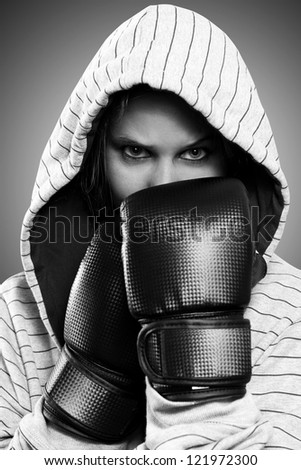 Black and white portrait of a woman with boxing gloves