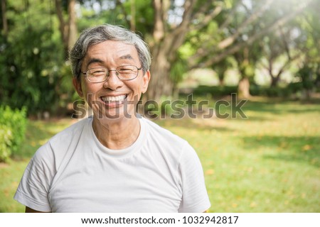 Portrait of healthy happy senior asian old man in the park outdoors with copy space. Spring healthcare lifestyle retirement concept
