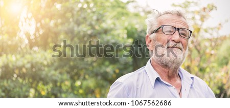 Portrait of stressful sad senior caucasian old man in the park outdoors with copy space. Spring healthcare lifestyle stress painful retirement golden age crisis concept banner