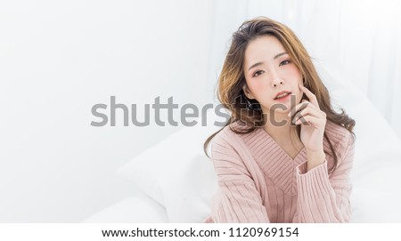 Portrait of young beautiful sexy asian woman relax in her bedroom. Smile happy face asian girl isolated on white background. Beauty treatment perfect clear skin japanese makeup  lifestyle concept