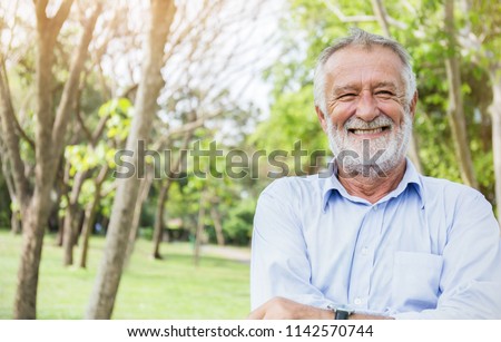 Portrait of healthy happy smile senior elderly caucasian old man in the park outdoors with copy space. Spring autumn golden age healthcare cheerful lifestyle freedom retirement concept