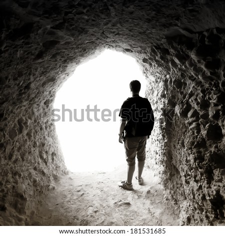 Man in a cave. Light at End of Tunnel