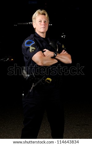 A female police officer in the night during her shift.
