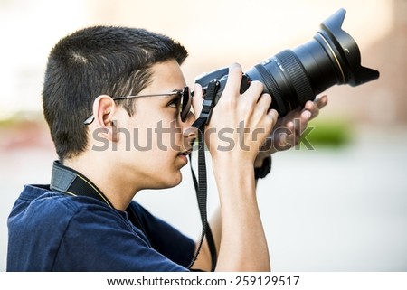 A 12 year old boy about to take a  photograph.