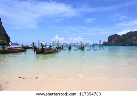 Picturesque native boats Longtail expect the first morning tourists. Magic beach on island.