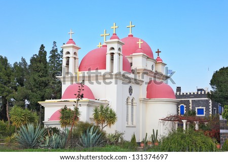 White walls, pink domes and golden crosses the Orthodox Church of the Twelve Apostles. The shore of Lake Kinneret.