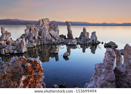 The magic of Mono Lake. Outliers - bizarre limestone calcareous tufa formation on the smooth water of the lake