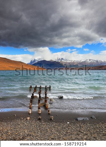 National Park Torres del Paine in Patagonia, Chile. Boat dock on the lake. Storm clouds, wind and waves at the Laguna Azul.