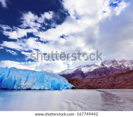 Blue Ice Glacier Gray is reflected in the lake. Journey to the End of the World. Chilean Patagonia in the sunlight