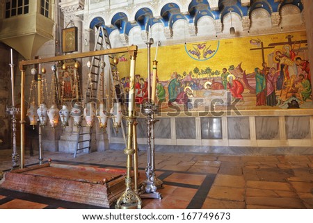Jerusalem - September 3, 2012: The oldest Christian sanctuary - Stone of Unction in the Temple of the Holy Sepulcher September 3, 2012 in Jerusalem. Fire burns in eight inextinguishable lamp
