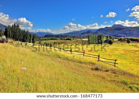 Picturesque rural landscape. Light wood fences are installed on the slopes of the hilly land. South America, Chile