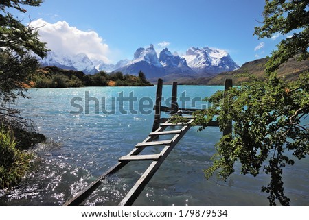 The National Park Torres del Paine, Chile. Boat dock on Lake Pehoe. On the opposite side of the lake majestic snow-capped cliffs of Los Kuernos