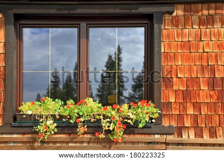 Dachstein huge tourist complex in Austrian Alps. Picturesque popular cafe window with flower pots