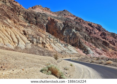 A great American road. The road to dry and wild-colored mountains of Death Valley