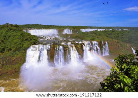 The magnificent rainbow costs over roaring water streams. The best-known falls in the world - Iguazu.  Brazilian party.