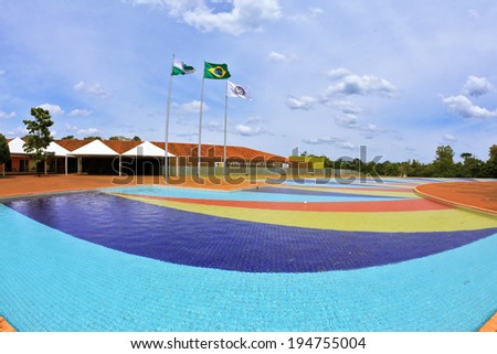 lIGUASSU FALLS NATIONAL PARK, BRAZIL - MARCH 2, 2013: The huge pool of water. The bottom of the pool is beautifully laid out with colorful tiles