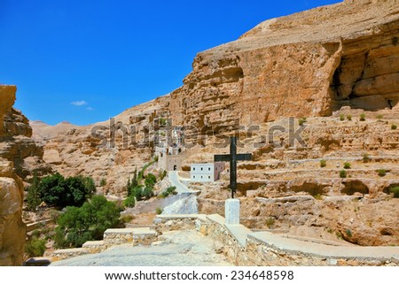 The road leading to the temple. Sacred George Hozevit\'s well-known monastery. The monastery is constructed to Vadi Kelt\'s gorges in vicinities of Jerusalem.  The guiding signpost - Black Cross