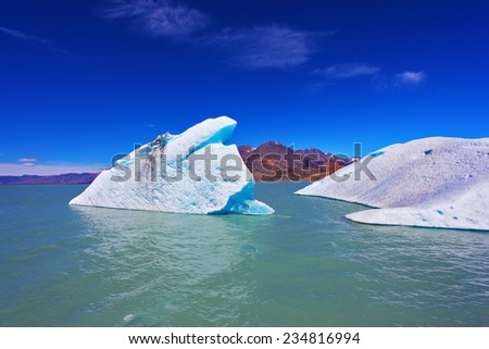 Huge white and blue icebergs floating in the icy water of emerald lake in Argentina. Unique lake Viedma in arid Patagonia