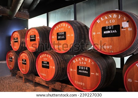 FUNCHAL, MADEIRA - OCTOBER 08, 2011: The museum - storage of expensive vintage wine Madeira. Huge barrels are marked by data of wine