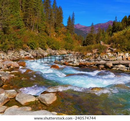 Pastoral in the Alpine mountain valley in Austria. Cascades of cold water at the source of the famous Krimml waterfalls.