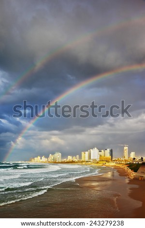 Storm and a rainbow in the Mediterranean. Promenade and a huge beach in Tel Aviv