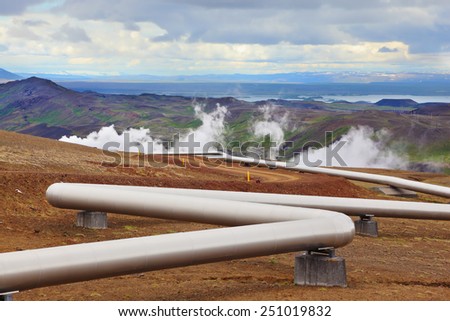Pipeline to transport hot water. Summer Iceland. Krafla Lake neighborhood. Steam rises above the hot ground