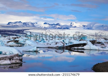 Reflection. Sunrise.  Blue and turquoise icebergs and ice floes are reflected in smooth water of the Gulf JÃ?Â¶kulsÃ?Â¡rlÃ?Â³n in Iceland
