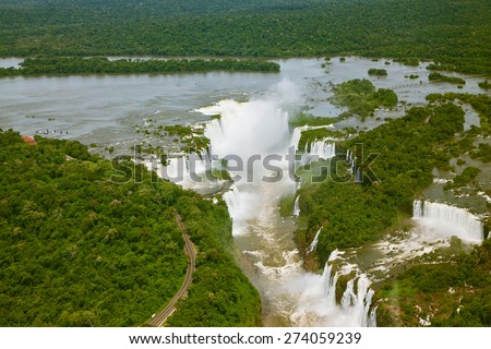 Devil\'s Throat - largest waterfall of the Iguazu Falls. Iguazu River spreads widely among the dense tropical forests. Picture taken from a helicopter