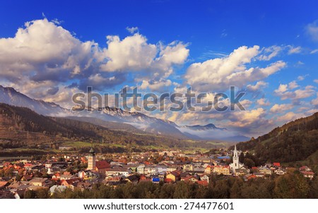 Gorgeous Austria. The road in the Alps. The small town and a white Lutheran church illuminated by the sun
