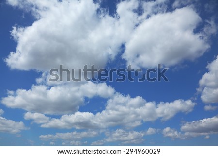 White light cumulus clouds in a high blue sky