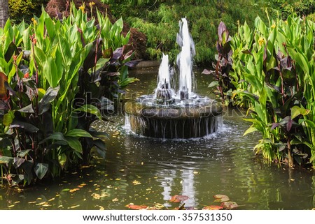 Small fountain in quiet pond. Autumn day in the park Butchart Gardens on Vancouver Island, Canada