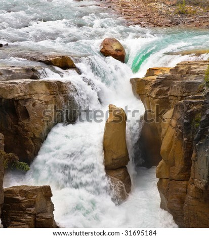 The rapid current. A falls in a narrow and deep canyon in the north of Canada