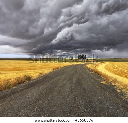 Thunder-storm above Montana. Fields after harvest and road