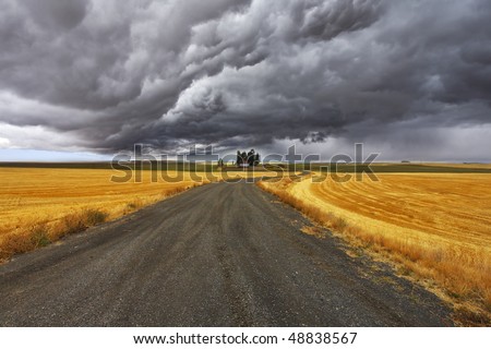 Thunder-storm above Montana. Fields after a harvest and road