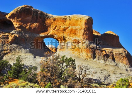 Natural hills of unusual forms from sandstone and through arches in park \